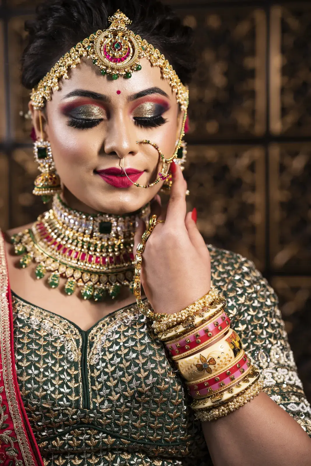 Close-up of bridal eye makeup with eyes closed and gold jewellery