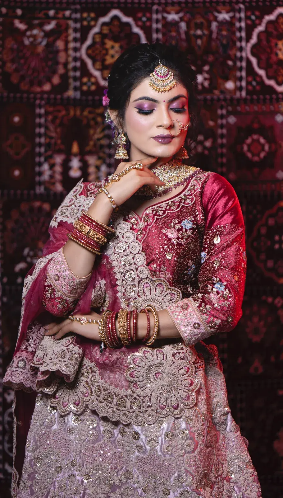 Bride in magenta in front of a patterned carpet backdrop